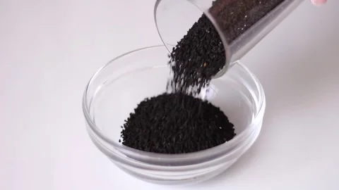Pouring glass can with black cumin seeds 動画素材 80799490