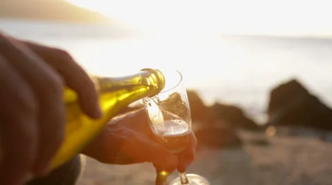 Pouring a glass of champagne at sunset Stock Footage