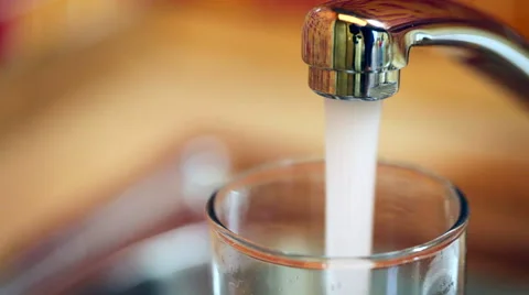 Pouring a glass with drinking water from kitchen tap 스톡 동영상 67573261