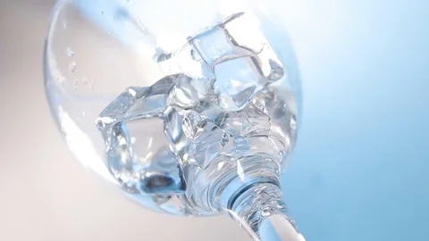 Pouring into the glass with ice cubes Stock Footage 116097177