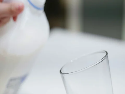 Pouring a glass of milk Stock Footage 80739375