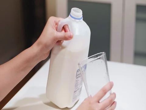 Pouring a glass of milk Stock Footage