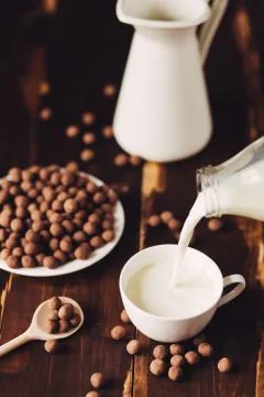 Pouring a glass of milk Stock Photos