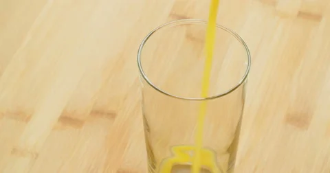 Pouring a Glass of Orange Juice Stock Footage
