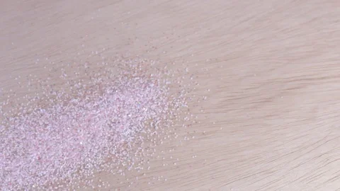 Pouring glitter on a wood table Stock Footage 92816054