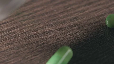 Pouring green capsules from a plastic jar Stock Footage 270412690