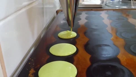 Pouring Green Macaron Batter Onto Baking Sheet close up Stock Footage 345292714
