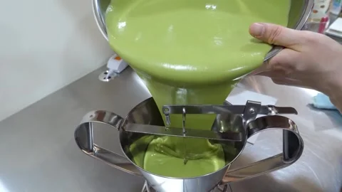 Pouring Green Matcha Batter Into Stainless Steel Confectionery Funnel Dispenser Stock Footage 345292549