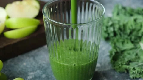 Pouring green smoothie in glass Stock Footage 155275494