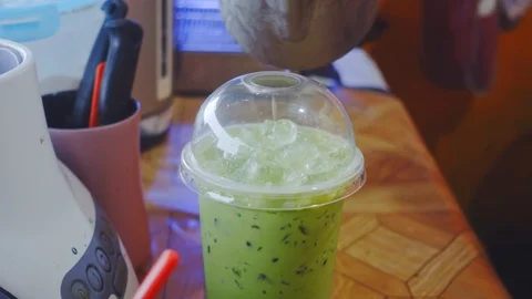 Pouring Green tea in a plastic cup. Stock Footage 117472557