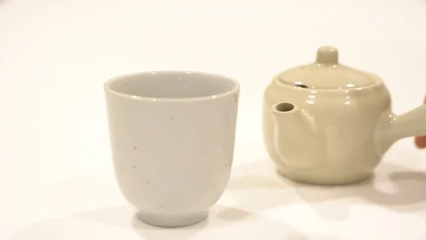 Pouring green tea in white cup japanese teapot Stock Footage 109855441
