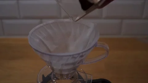 Pouring grinded coffee in to filter slow motion Stock Footage 146947580