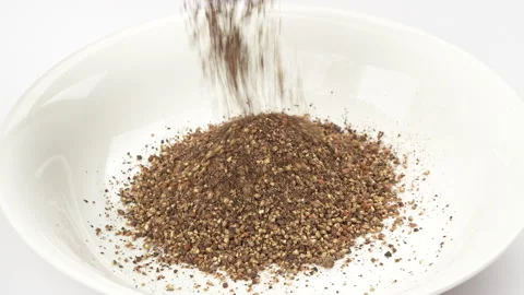 Pouring Ground Black Pepper Powder Onto White Plate Close Up 動画素材 331114992