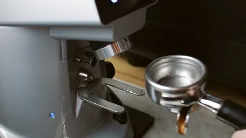 Pouring ground coffee from a coffee grinder Stock Footage 138355859