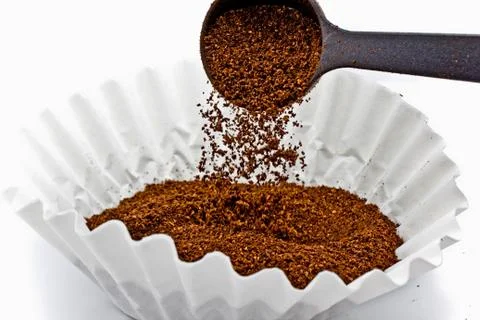 Pouring ground coffee 스톡 사진