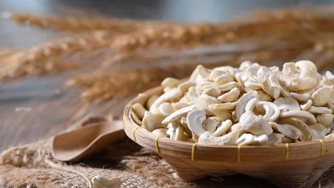 Pouring half raw cashews on bamboo basket, Video stock 133123151