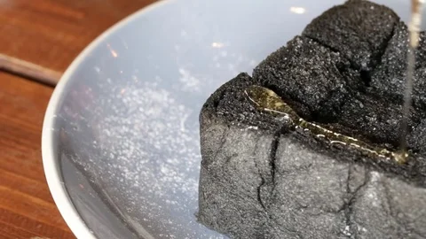 Pouring honey on the black bread. Stock Footage 81637865