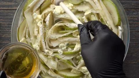 Pouring honey on raw phyllo pie with pear and cheese top view Stock Footage 327459302