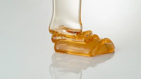 Pouring honey on reflective surface. Slow Motion. Stock Footage 51805397