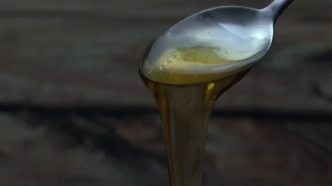 Pouring honey from spoon 스톡 동영상 78864498