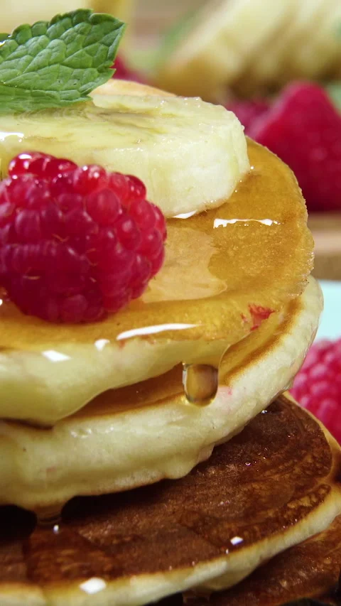 Pouring honey on stack of pancakes. Tasty breakfast food Stock Footage 274745570
