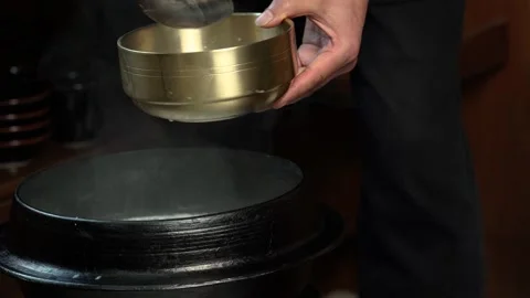 Pouring Hot Beef Bone Soup into Bowl 動画素材 334638468