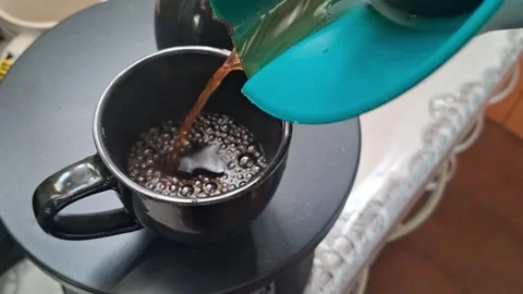 Pouring hot coffee into black ceramic mug video motion clip Video stock 339248214