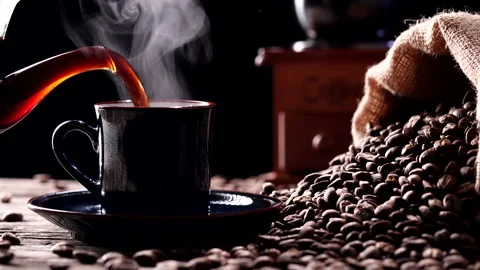 Pouring hot coffee into coffee cup, beans, natural steam smoke, hot drink Stock Footage 219256341