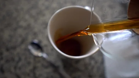 Pouring hot coffee into a cup Stock Footage 89923649