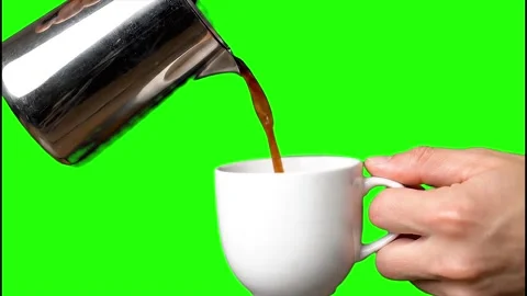 Pouring hot coffee into white cup with green screen background 4k video Stock Footage 317932983