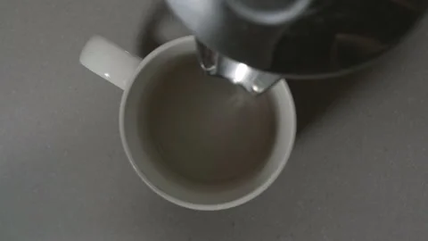 Pouring a hot fresh cup of dark coffee, from a birds eye view,  60fps slow 스톡 동영상 132397341
