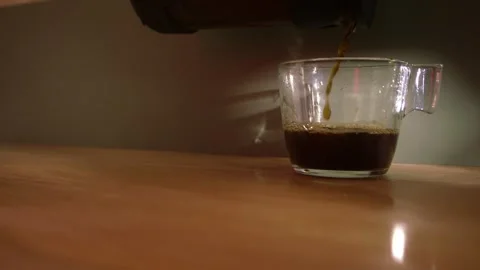 Pouring hot mug of steaming coffee on desk Stock Footage 346772036