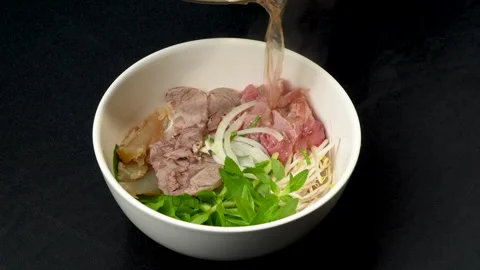 Pouring Hot Steaming Broth into Vietnamese Pho Bowl Stock Footage 339656656
