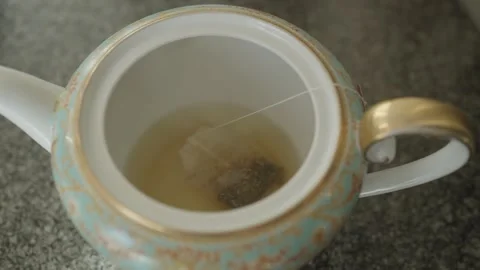 Close-up of Man Holding Thermos and an Iron Mug, Pouring Hot Tea