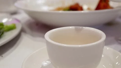 Pouring hot tea inside Chinese restaurant with 4k resolution. Stock Footage 78480285