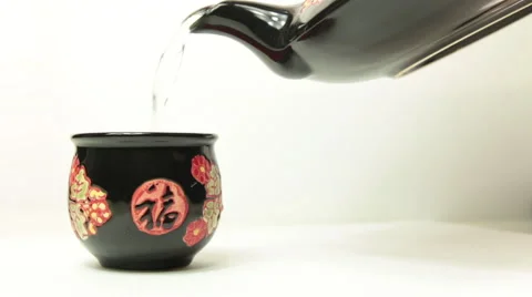 Pouring hot tea with oriental teapot in his cup Stock Footage 54036780