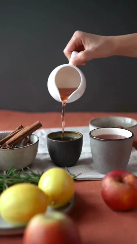 Pouring Hot Tea into Rustic Ceramic Cup on Autumn Table Stock Footage 344016748