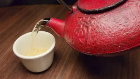 Pouring Hot Tea into A Teacup Stock Footage 229243540