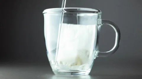 Pouring hot water onto chamomile tea bag Stock Footage 8573000