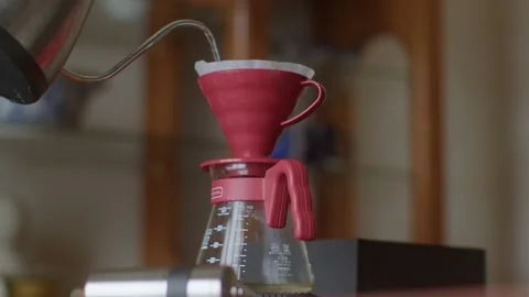 Pouring Hot Water into Coffee Dripper 4k Stock Footage 168948339