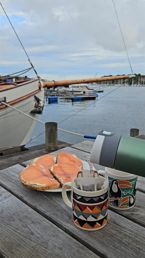 Pouring hot water into drip coffee bag on wooden pier in Stavanger. Stock Footage 340242534