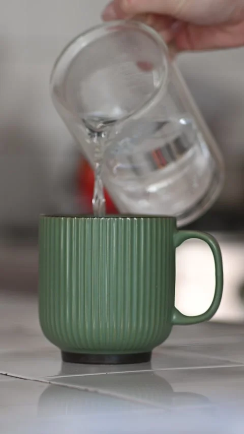 Pouring hot water into a mug Stock Footage 309550341
