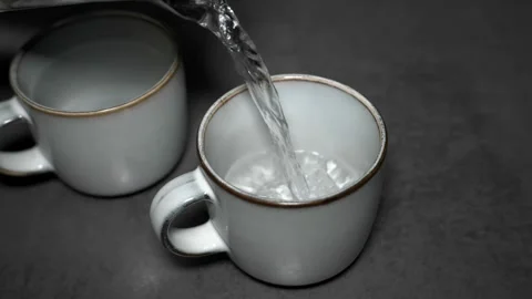 Pouring Hot Water into Tea Cup in Slow Motion Stock-Footage 319449578