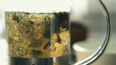 Pouring hot water in teapot with tea HD Stock Footage