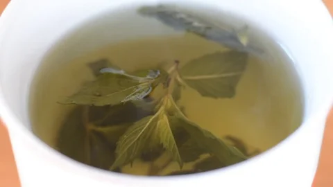 Pouring hot watter into mint tea. Stock Footage 74290845