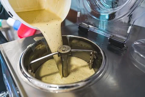 Pouring ice cream mix into a pasteurizing machine Stock Photos