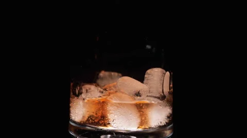 Pouring ice cubes and cola coke in cold glass slow motion Stock Footage 147447485