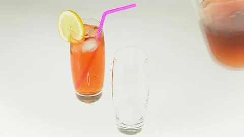 Pouring Iced Tea Glasses on White Stock Footage 79585926