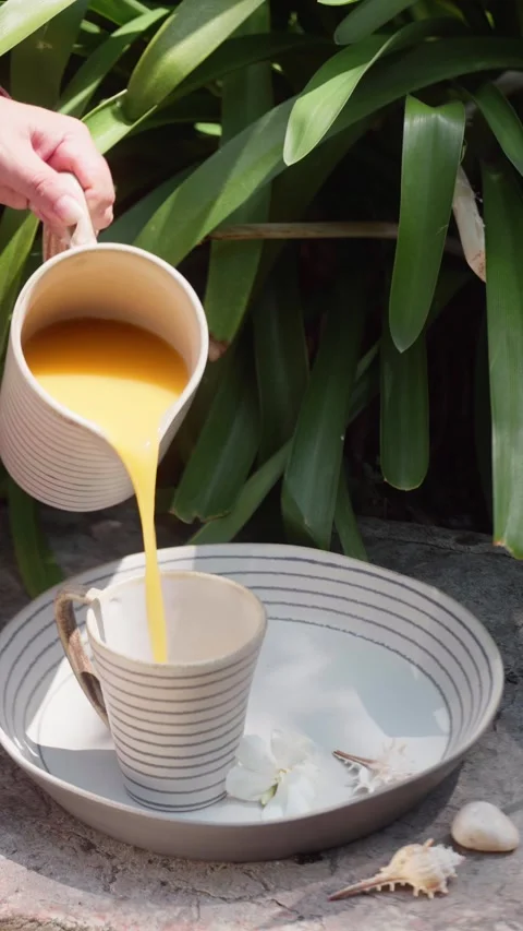 Pouring Juice into a Cup in an Outdoor Setting Stock Footage 340670125