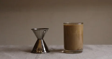 Pouring kahlua into glass cup with cafe latte Stock Footage 105552075